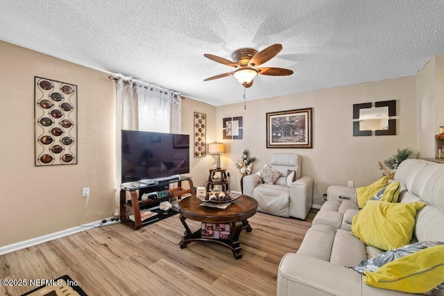2548 Haywood Estates Ln, Jacksonville, FL 32233 - living room with ceiling fan, light wood-style floors, and a textured ceiling