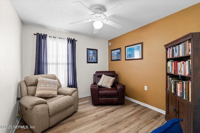 2548 Haywood Estates Ln, Jacksonville, FL 32233 - sitting room with light wood finished floors, ceiling fan, and a textured ceiling