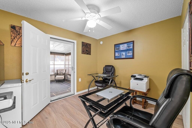 2548 Haywood Estates Ln, Jacksonville, FL 32233 - home office with light wood-style floors, a textured ceiling, a ceiling fan, and washer / dryer