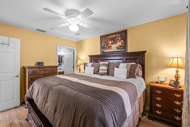 2548 Haywood Estates Ln, Jacksonville, FL 32233 - bedroom featuring light wood finished floors, a ceiling fan, and a textured ceiling