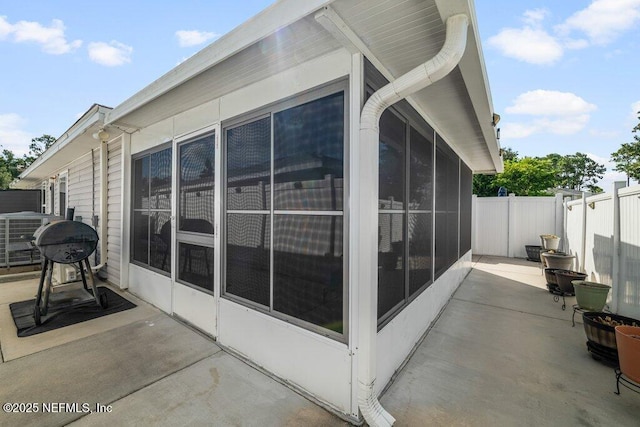 2548 Haywood Estates Ln, Jacksonville, FL 32233 - view of property exterior with a sunroom, a patio area, and a fenced backyard