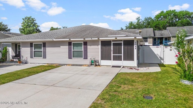 2548 Haywood Estates Ln, Jacksonville, FL 32233 - back of house featuring a gate, a sunroom, and roof with shingles