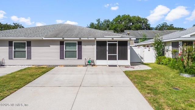 2548 Haywood Estates Ln, Jacksonville, FL 32233 - rear view of house with a sunroom, a gate, and a shingled roof