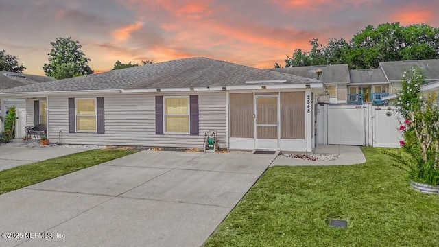 2548 Haywood Estates Ln, Jacksonville, FL 32233 - back of property at dusk featuring a shingled roof and a gate