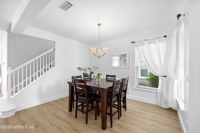 1563 Tawny Marsh Ct, Saint Augustine, FL 32092 - dining room featuring light wood-type flooring, stairs, and a chandelier