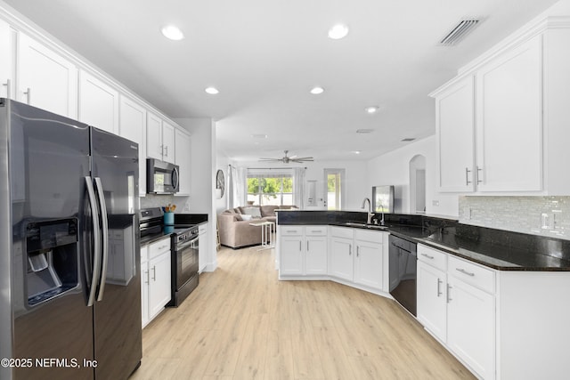 1563 Tawny Marsh Ct, Saint Augustine, FL 32092 - kitchen featuring appliances with stainless steel finishes, open floor plan, recessed lighting, white cabinets, and backsplash