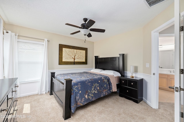 1563 Tawny Marsh Ct, Saint Augustine, FL 32092 - bedroom featuring light carpet, ceiling fan, ensuite bathroom, and a textured ceiling