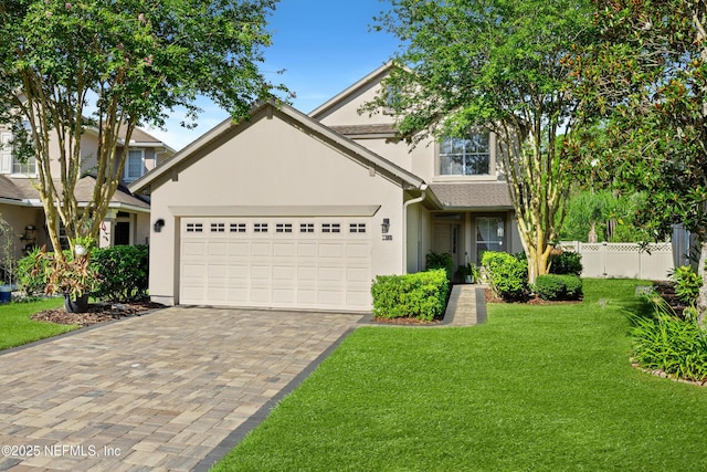 1563 Tawny Marsh Ct, Saint Augustine, FL 32092 - view of front facade with an attached garage, decorative driveway, and stucco siding