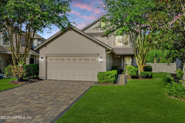 1563 Tawny Marsh Ct, Saint Augustine, FL 32092 - view of front of house with stucco siding, an attached garage, and driveway
