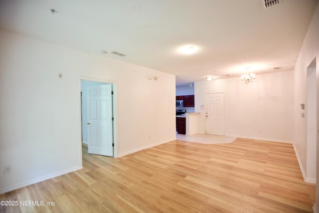 3600 Lenin Peak Ct Unit 8, Jacksonville, FL 32210 - unfurnished living room with a chandelier and light wood-type flooring