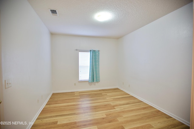 3600 Lenin Peak Ct Unit 8, Jacksonville, FL 32210 - spare room with light wood finished floors and a textured ceiling