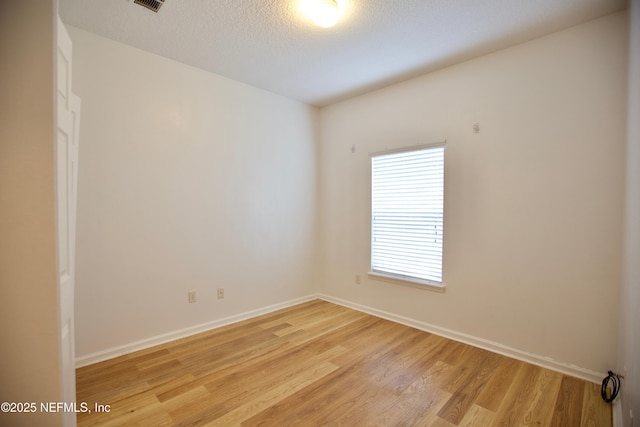 3600 Lenin Peak Ct Unit 8, Jacksonville, FL 32210 - unfurnished room with light wood-style floors and a textured ceiling