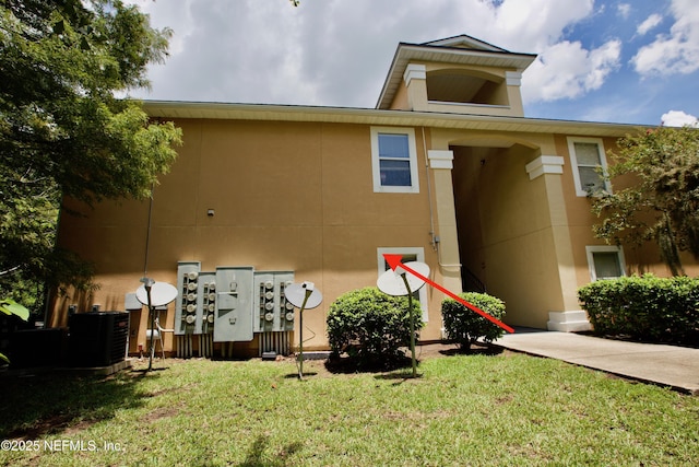 3600 Lenin Peak Ct Unit 8, Jacksonville, FL 32210 - back of house featuring stucco siding and a yard