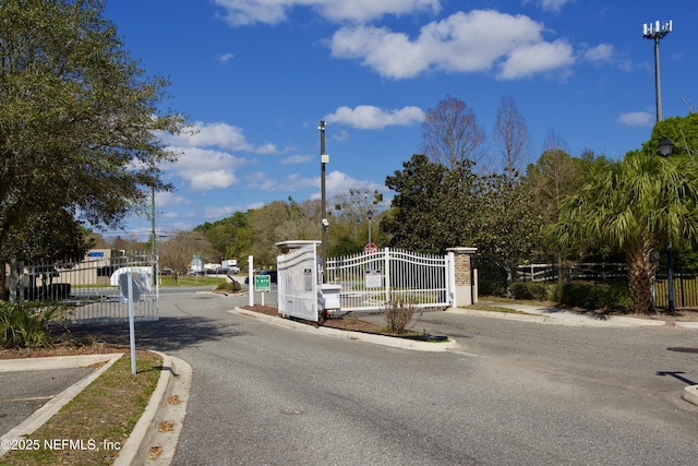 3600 Lenin Peak Ct Unit 8, Jacksonville, FL 32210 - view of asphalt street featuring curbs, a gate, street lighting, and a gated entry