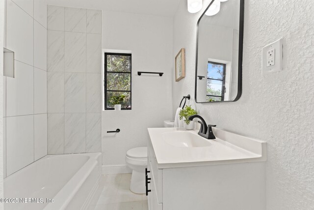6285 Spring Forest Cir, Jacksonville, FL 32216 - bathroom featuring a textured wall, vanity, and bathtub / shower combination