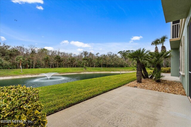 1200 Canopy Walk Ln Unit 1212, Palm Coast, FL 32137 - view of green lawn featuring a water view and a patio