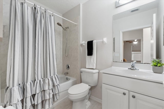 1200 Canopy Walk Ln Unit 1212, Palm Coast, FL 32137 - bathroom with vanity, shower / bath combo with shower curtain, ceiling fan, a textured ceiling, and tile patterned floors