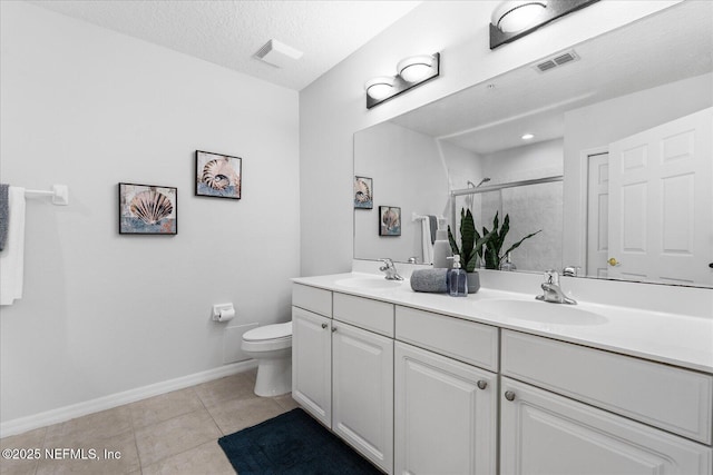 1200 Canopy Walk Ln Unit 1212, Palm Coast, FL 32137 - full bath featuring double vanity, a shower stall, tile patterned floors, and a textured ceiling