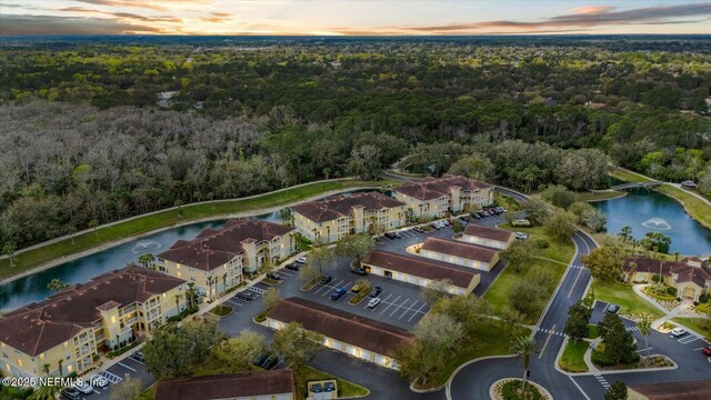 1200 Canopy Walk Ln Unit 1212, Palm Coast, FL 32137 - aerial view at dusk of a water view, a wooded view, and a view of apartment building / complex
