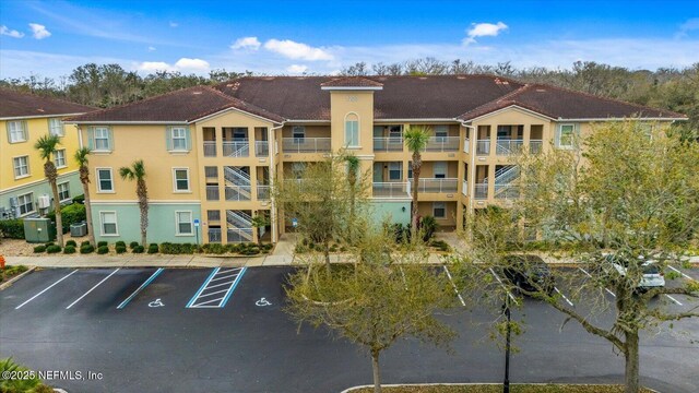 1200 Canopy Walk Ln Unit 1212, Palm Coast, FL 32137 - view of apartment building / complex featuring uncovered parking