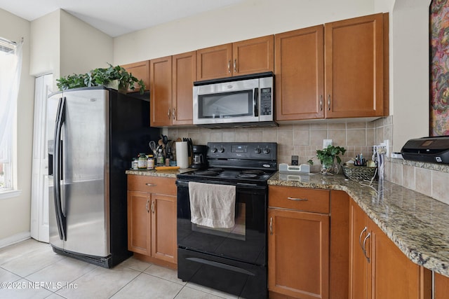 10435 Mid Town Pkwy Unit 265, Jacksonville, FL 32246 - kitchen featuring stainless steel appliances, brown cabinets, and backsplash