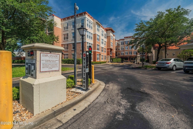 10435 Mid Town Pkwy Unit 265, Jacksonville, FL 32246 - view of asphalt street with street lights, curbs, and traffic signs