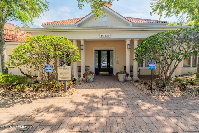 10435 Mid Town Pkwy Unit 265, Jacksonville, FL 32246 - doorway to property featuring stucco siding and covered porch