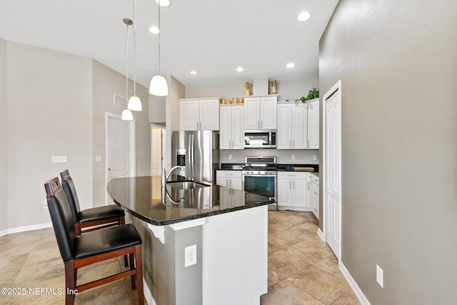 222 Green Turtle Ln, Saint Augustine, FL 32086 - kitchen featuring appliances with stainless steel finishes, white cabinets, a center island with sink, a breakfast bar area, and recessed lighting