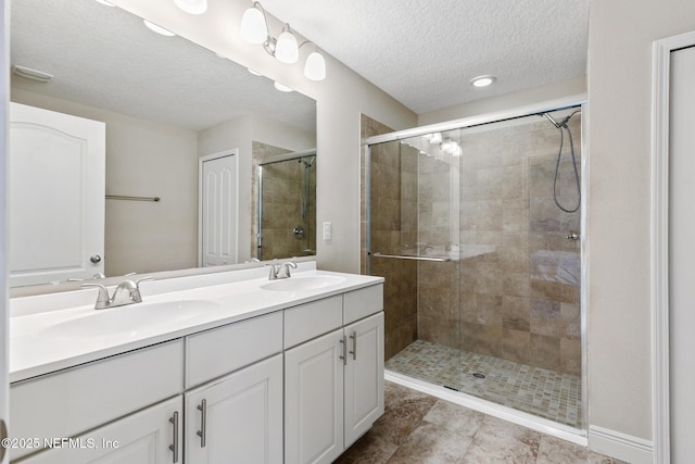 222 Green Turtle Ln, Saint Augustine, FL 32086 - full bathroom featuring double vanity, a shower stall, and a textured ceiling
