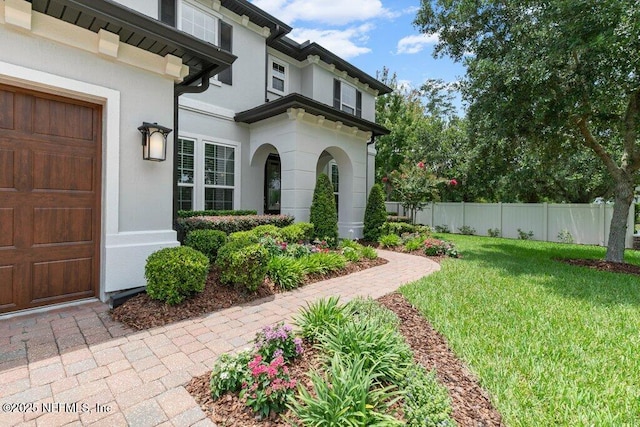26 Traveler Palm Ct, Ponte Vedra Beach, FL 32082 - view of exterior entry featuring stucco siding and a garage