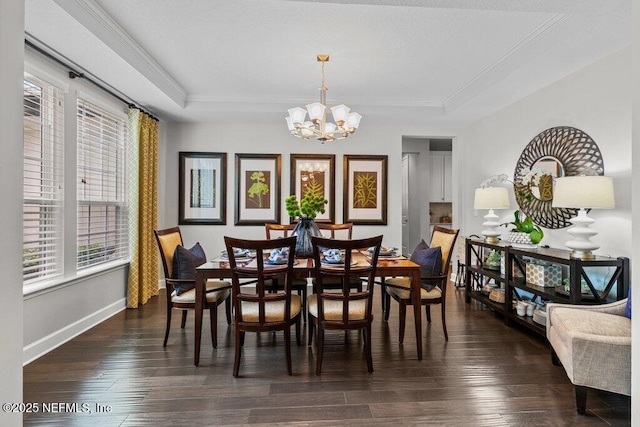 26 Traveler Palm Ct, Ponte Vedra Beach, FL 32082 - dining room with a chandelier, healthy amount of natural light, a tray ceiling, ornamental molding, and dark wood-style floors