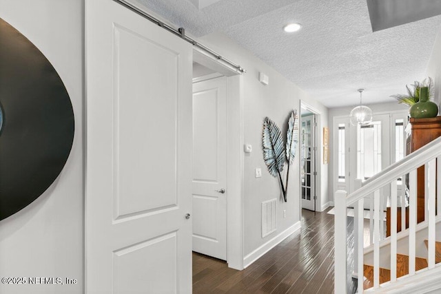 26 Traveler Palm Ct, Ponte Vedra Beach, FL 32082 - corridor featuring a textured ceiling, dark wood finished floors, and a barn door