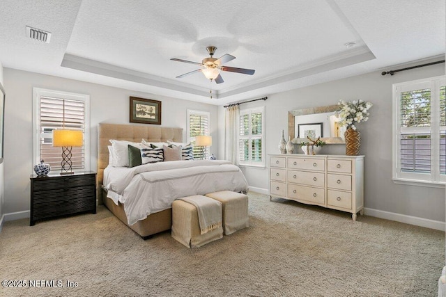 26 Traveler Palm Ct, Ponte Vedra Beach, FL 32082 - bedroom featuring a tray ceiling, light carpet, a textured ceiling, and a ceiling fan