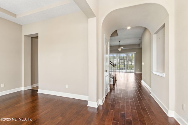 1306 Warbler Way, Middleburg, FL 32068 - hallway with arched walkways and dark wood-type flooring
