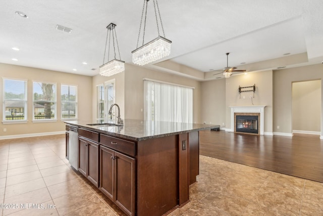1306 Warbler Way, Middleburg, FL 32068 - kitchen with open floor plan, ceiling fan, dark stone countertops, light tile patterned floors, and recessed lighting