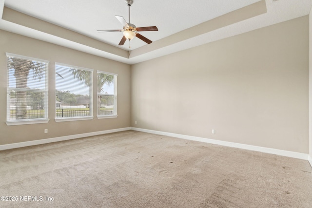 1306 Warbler Way, Middleburg, FL 32068 - carpeted spare room with a ceiling fan and a tray ceiling