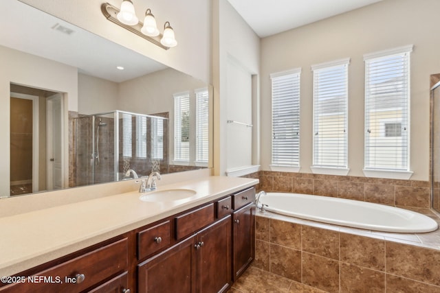 1306 Warbler Way, Middleburg, FL 32068 - bathroom featuring vanity, a shower stall, a bath, and a spacious closet