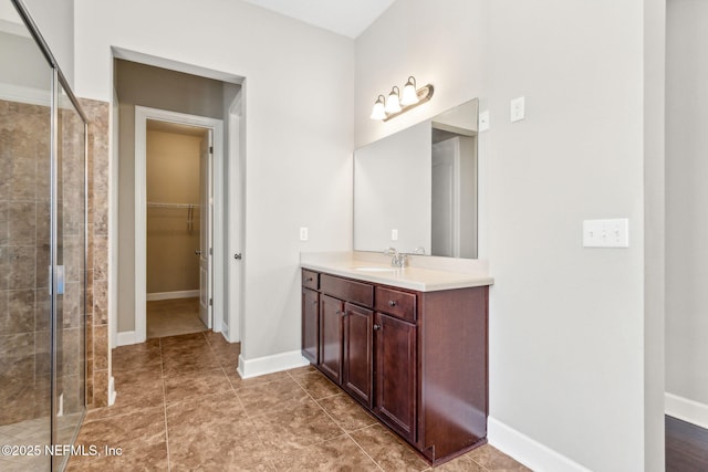 1306 Warbler Way, Middleburg, FL 32068 - bathroom featuring vanity, a stall shower, and a walk in closet