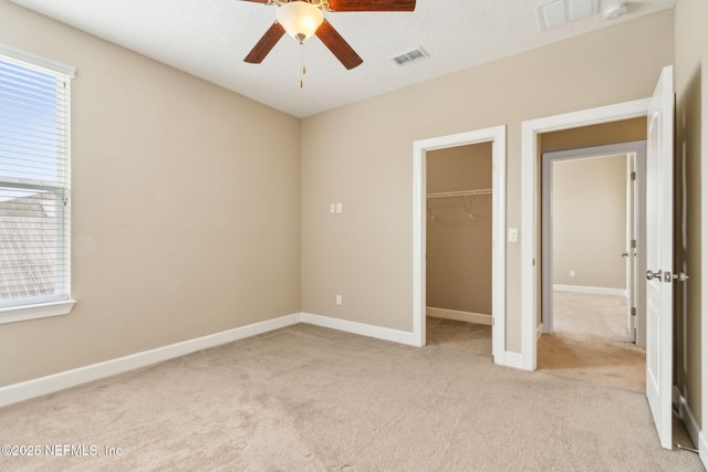 1306 Warbler Way, Middleburg, FL 32068 - unfurnished bedroom featuring light carpet, a spacious closet, and a ceiling fan