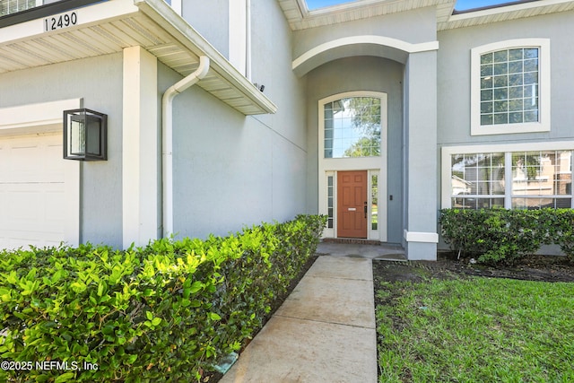 12490 Tropic Dr, Jacksonville, FL 32225 - entrance to property featuring stucco siding and a garage