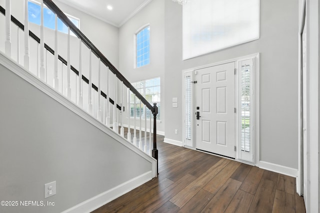 12490 Tropic Dr, Jacksonville, FL 32225 - entrance foyer with dark wood-style flooring, a towering ceiling, stairway, and ornamental molding