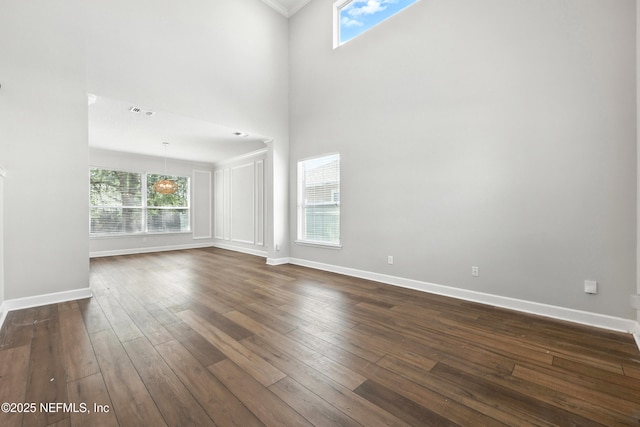 12490 Tropic Dr, Jacksonville, FL 32225 - spare room featuring dark wood-type flooring, a towering ceiling, and ornamental molding