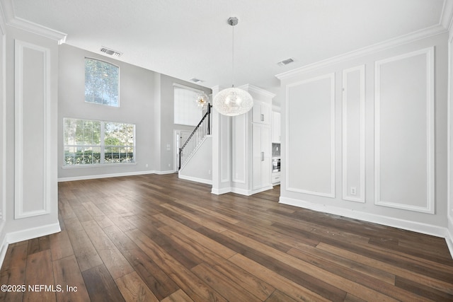 12490 Tropic Dr, Jacksonville, FL 32225 - unfurnished dining area with dark wood-style flooring, stairway, crown molding, and a chandelier