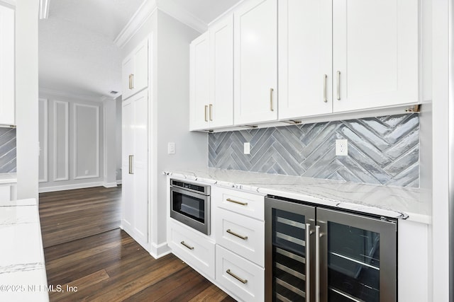 12490 Tropic Dr, Jacksonville, FL 32225 - kitchen featuring wine cooler, backsplash, dark wood-style floors, light stone counters, and white cabinets