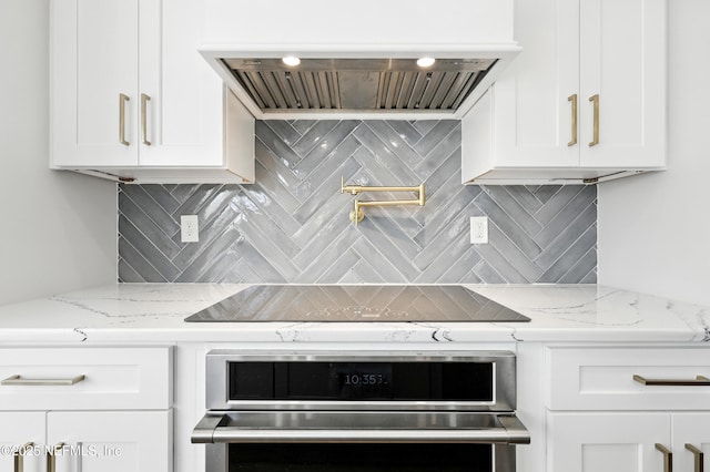 12490 Tropic Dr, Jacksonville, FL 32225 - kitchen featuring premium range hood, white cabinetry, stainless steel oven, and backsplash