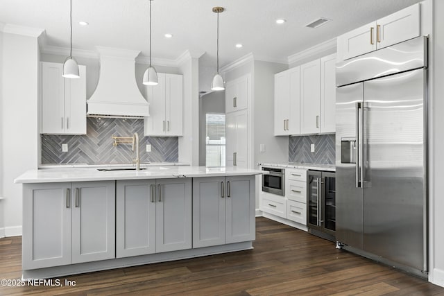 12490 Tropic Dr, Jacksonville, FL 32225 - kitchen featuring stainless steel appliances, custom exhaust hood, wine cooler, crown molding, and tasteful backsplash