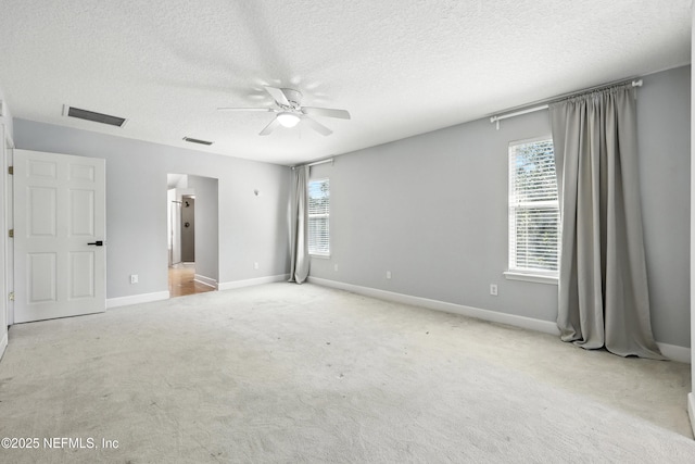 12490 Tropic Dr, Jacksonville, FL 32225 - unfurnished bedroom with multiple windows, a textured ceiling, carpet, and ceiling fan