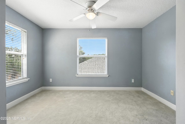 12490 Tropic Dr, Jacksonville, FL 32225 - empty room featuring plenty of natural light, carpet, a ceiling fan, and a textured ceiling