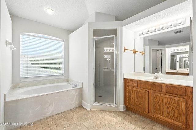 12490 Tropic Dr, Jacksonville, FL 32225 - bathroom with vanity, a bath, a stall shower, and a textured ceiling