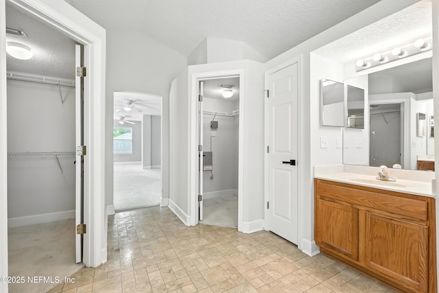 12490 Tropic Dr, Jacksonville, FL 32225 - bathroom featuring a ceiling fan, vanity, and a walk in closet